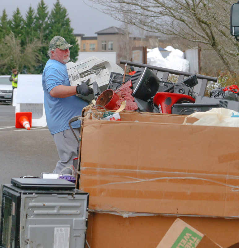 A man hauls electronics for recycling